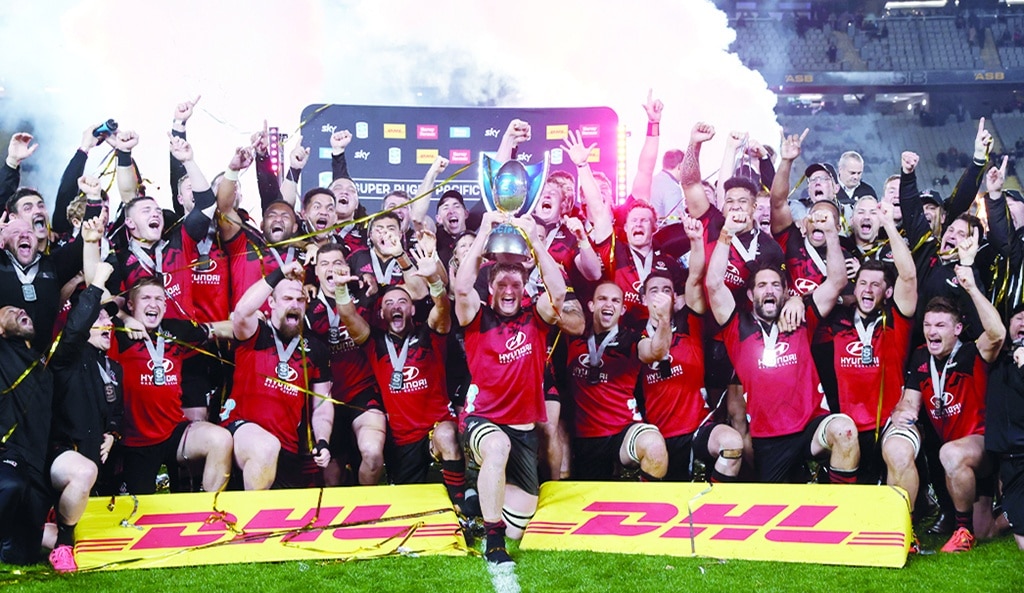 AUCKLAND: Scott Barrett of the Crusaders (center) and teammates celebrate winning the Super Rugby Pacific final between the Blues and the Crusaders at Eden Park in Auckland on June 18, 2022.- AFP