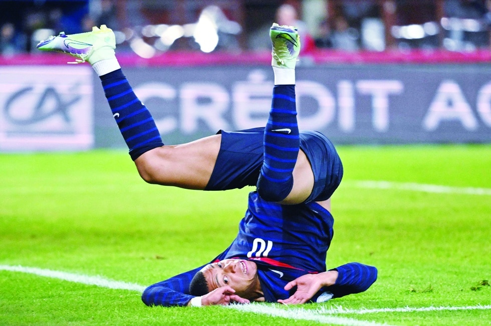 France's forward Kylian Mbappe falls as he scores the 1-1 during the UEFA Nations League football match Austria v France at the Ernst Happel stadium in Vienna, Austria on June 10, 2022. (Photo by Joe Klamar / AFP)