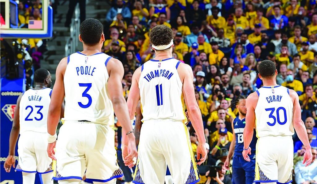SAN FRANCISCO: Jordan Poole #3, Klay Thompson #11, and Stephen Curry #30 of the Golden State Warriors walk downcourt during the game against the Dallas Mavericks during Game 2 of the 2022 NBA Playoffs Western Conference Finals on May 20, 2022 at Chase Center in San Francisco, California. - AFP