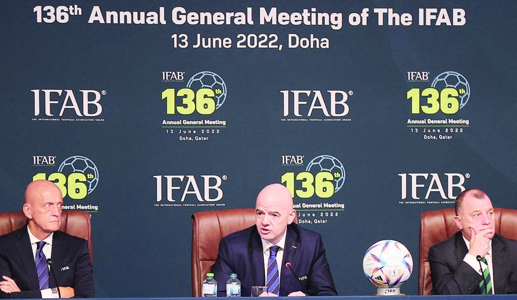 DOHA: FIFA president Gianni Infantino (center), FIFA referees committee chairman Pierluigi Collina (left), and Irish Foootball Association CEO Patrick Nelson attend the 137th International Football Association Board (IFAB) meeting in the Qatari capital Doha on June 13, 2022. - AFP
