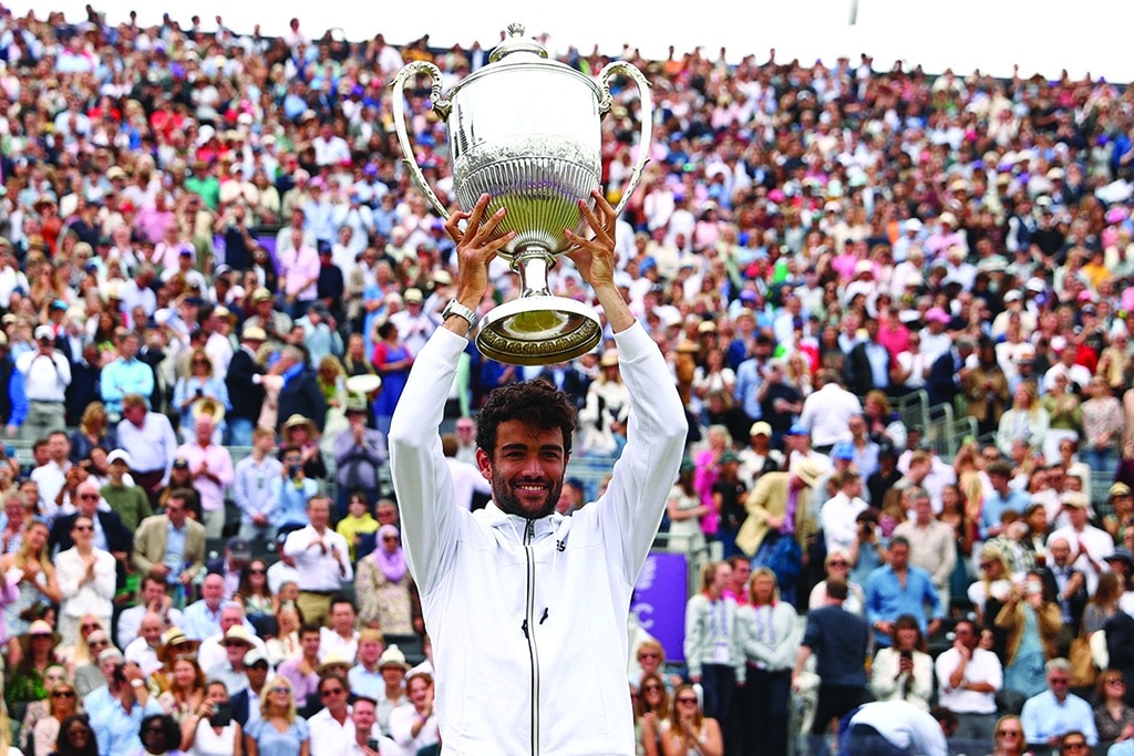 LONDON: Italy's Matteo Berrettini poses for a photograph as he celebrates with the trophy after his win in his men's singles final tennis match against Serbia's Filip Krajinovic on Day 7 of the cinch ATP Championships at Queen's Club in west London, on June 19, 2022. - AFP