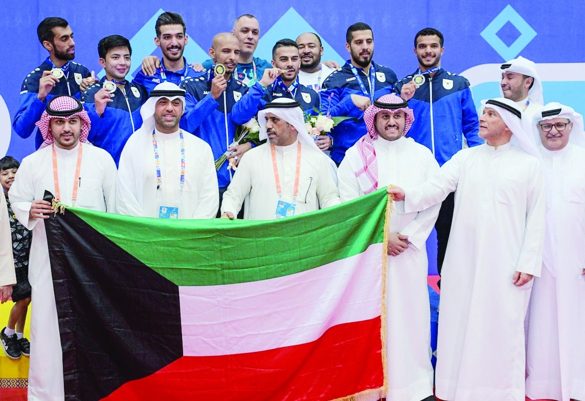 KUWAIT: Kuwait's karate players pose on the podium with their medals.