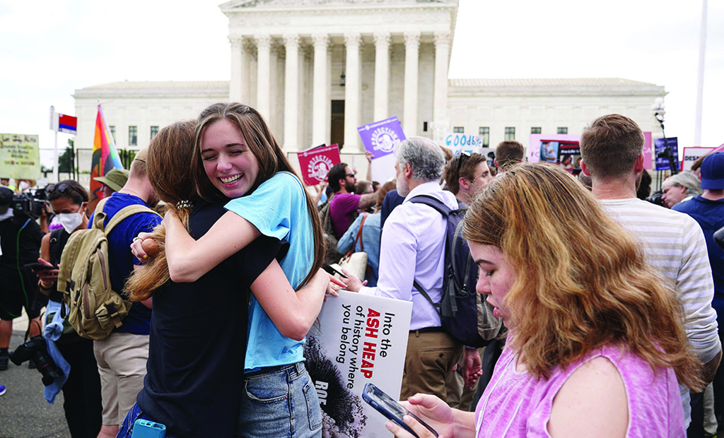WASHINGTON: Pro-life supporters hug outside the US Supreme Court on June 24, 2022. - AFP