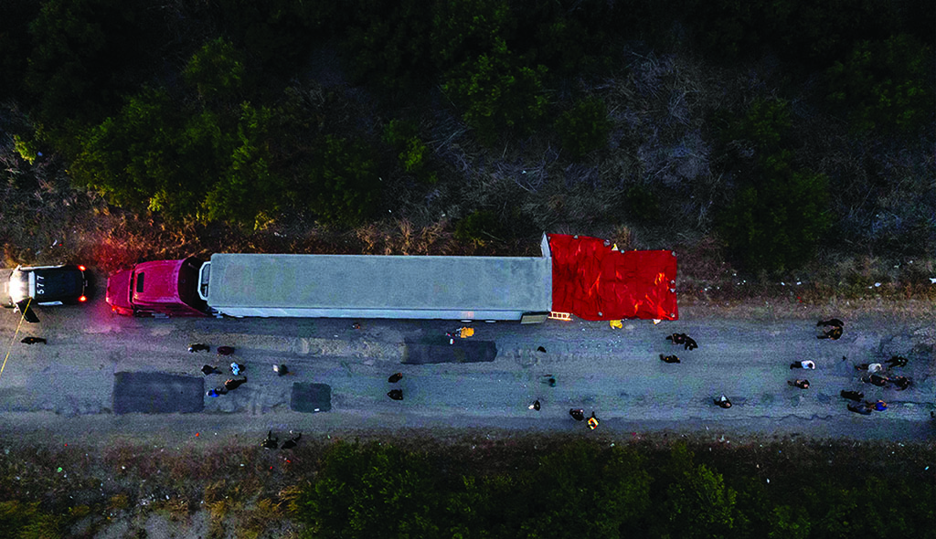 SAN ANTONIO, Texas: In this aerial view, members of law enforcement investigate a tractor trailer on June 27, 2022. - AFP
