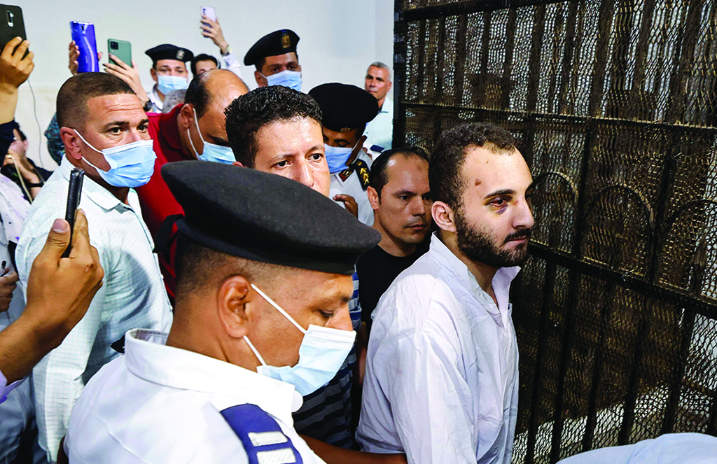 MANSOURA, Egypt: Alleged murderer Egyptian Mohamed Adel is surrounded by guards as he is taken out after his first trial session at the Mansoura courthouse on June 26, 2022. - AFP
