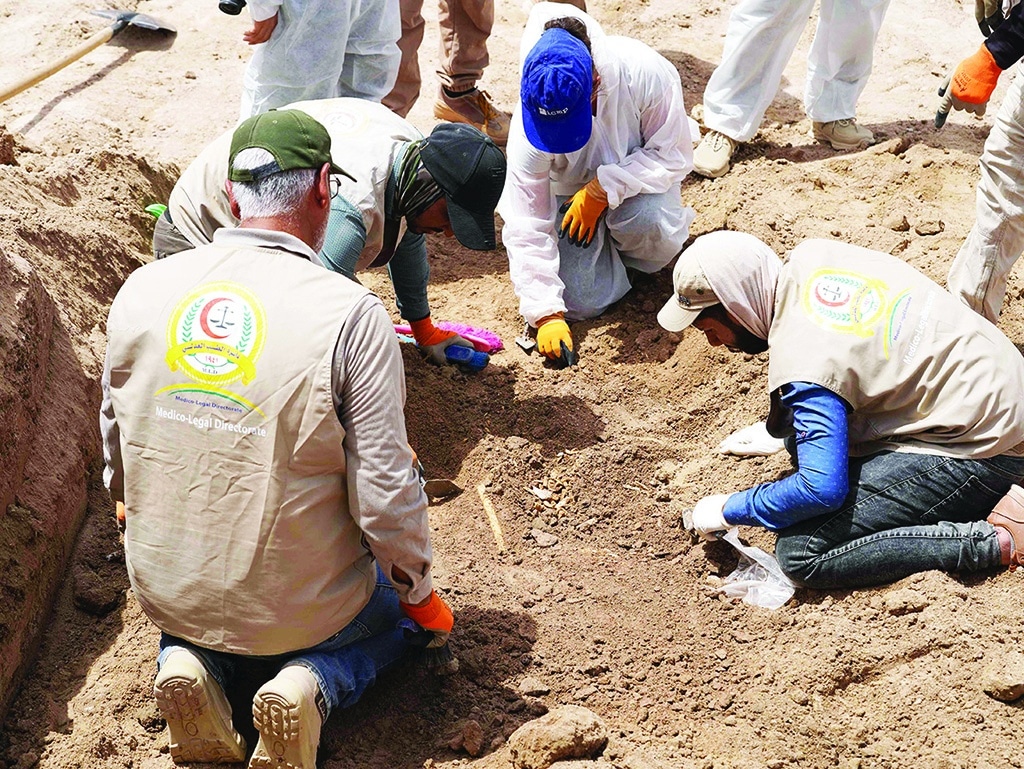 NAJAF: Forensics experts work at the site of a mass grave, discovered by chance when property developers wanted to prepare the land for construction, on May 18, 2022. – AFP