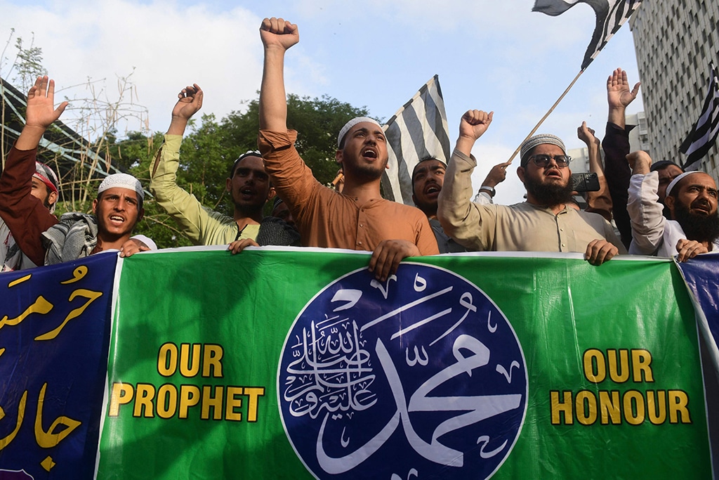 Supporters of Pakistan's Islamic and political Jamiat Ulema Islam-Fazal (JUI-F) party shout anti-India slogans against the remarks about the Prophet Mohammed made by an official from India’s ruling party, during a demonstration in Karachi on June 6, 2022. (Photo by Asif HASSAN / AFP)