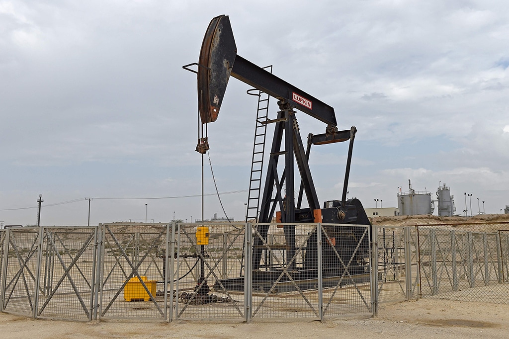 A pumpjack operates in the desert oil fields of Sakhir in southern Bahrain on April 22, 2020. (Photo by Mazen Mahdi / AFP)
