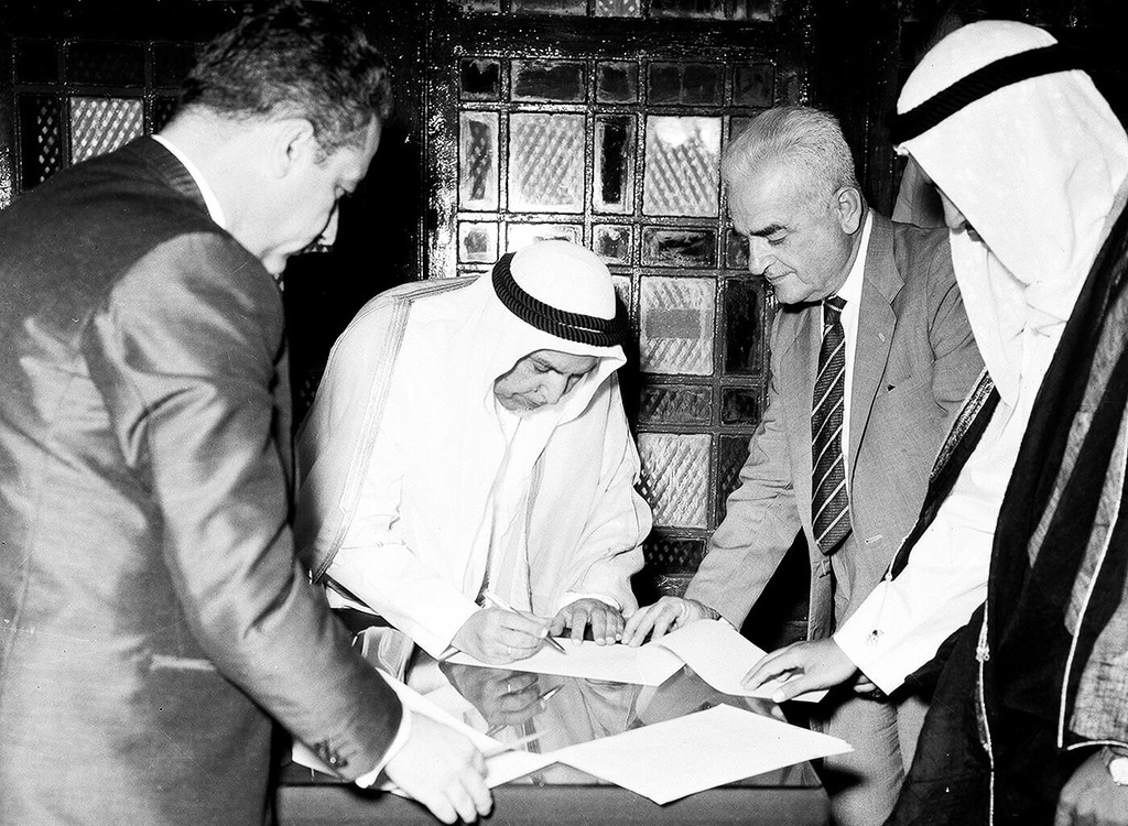 KUWAIT: The late Amir Sheikh Abdullah Al-Salem Al-Sabah signs the document of independence on June 19, 1961. - KUNA photos