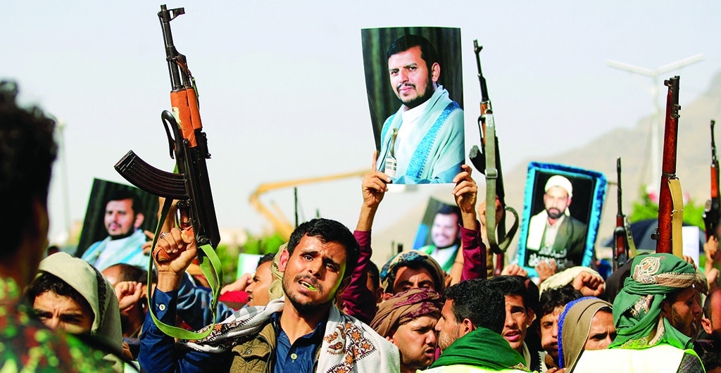 SANAA: Supporters of Yemen's Houthi rebels raise portraits of their leader Abdul Malik Al-Houthi during rally in the capital Sanaa after the country's warring parties agreed to renew a two-month truce. - AFP