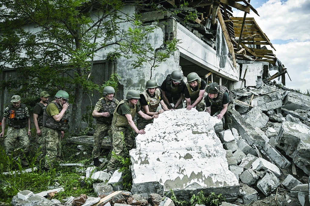 LYSYCHANSK, Ukraine: Ukrainian soldiers inspect a destroyed warehouse reportedly targeted by Russian troops in the eastern Ukrainian region of Donbas on June 17, 2022. - AFP