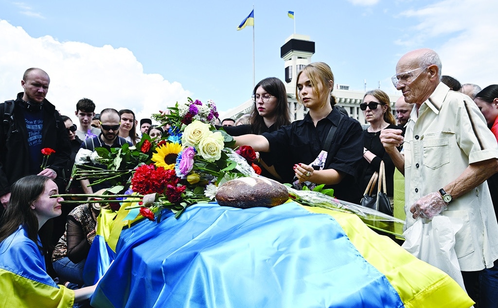 KYIV: Mourners pay their respects next to the coffin of killed Ukrainian serviceman Roman Ratushny during a farewell ceremony in Kyiv, amid the Russian invasion of Ukraine. - AFP