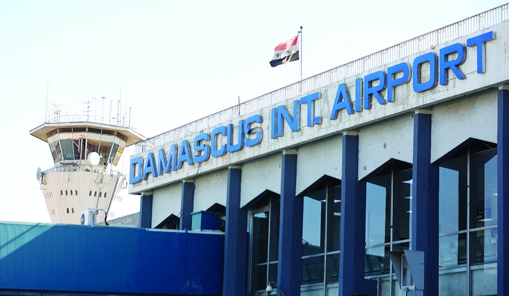 DAMASCUS: The Syrian flag flies at Damascus International Airport outside Syria's capital. All flights to and from Syria's capital were halted on June 10, 2022 after the Zionist entity's air strikes wounded at least one civilian and reportedly caused damage to an airport runway. - AFP