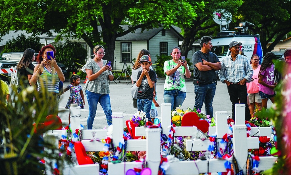 UVALDE, United States: People pay tribute and mourn at a makeshift memorial for the victims of the Robb Elementary School shooting in Uvalde, Texas, May 31, 2022. The traumatized Texas town of Uvalde began on Tuesday laying to rest the 19 young children killed in an elementary school shooting that left the small, tight-knit community united in grief and anger. - AFP