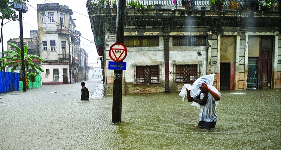 HAVANA, Cuba: Men wade along a flooded street in Havana. The remnant of Hurricane Agatha is causing intense and persistent rains this Friday in the western and central provinces of Cuba.—AFP