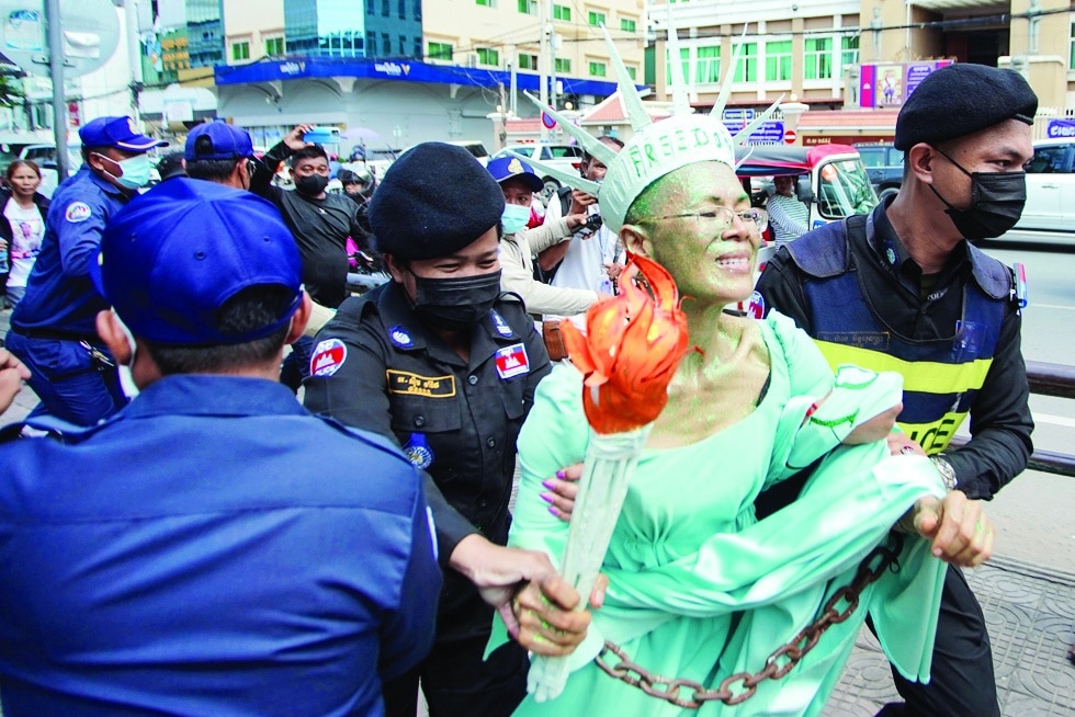 PHNOM PENH, Cambodia: Cambodian-US human rights advocate Theary Seng, dressed as Lady Liberty, is arrested by police after being found guilty of treason in her trial in front of the Phnom Penh municipal court on June 14, 2022. – AFP