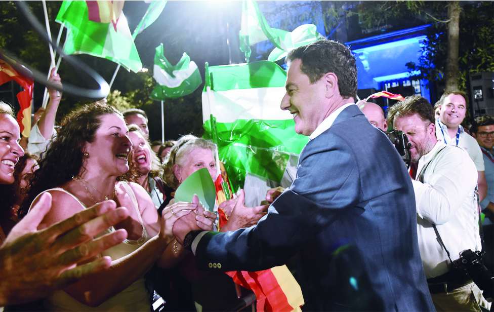 SEVILLE: Partido Popular (PP) candidate for the Andalusian regional election Juanma Moreno greets supporters during a meeting following the Andalusian regional elections, in Seville. - AFP