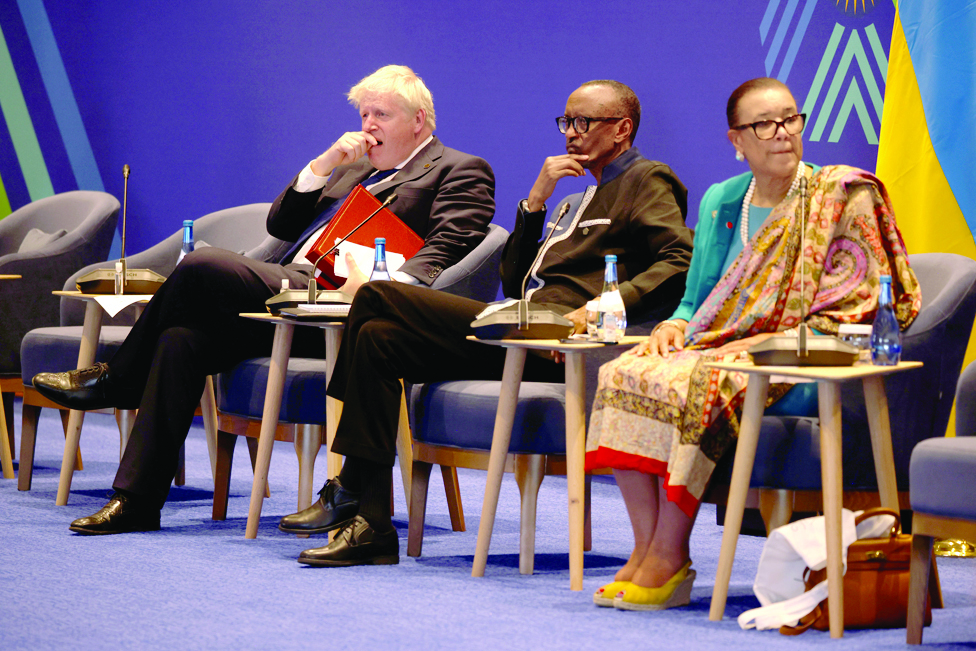 KIGALI, Rwanda: (L/R): Britain's Prime Minister Boris Johnson yawns as he sits alongside Rwanda's President Paul Kagame and Secretary-General of the Commonwealth of Nations Patricia Scotland during the Leaders' Retreat executive session on the sidelines of day six of the 2022 Commonwealth heads of Government meeting at the Intare Conference centre in Kigali. - AFP