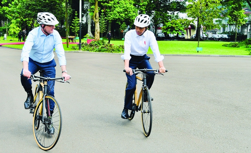 BOGOR, Indonesia: Handout photo released by the Presidential Palace on June 6, 2022 shows Indonesia's President Joko Widodo (R) and Australia's Prime Minister Anthony Albanese (L) riding bamboo bicycles at the Presidential Palace in Bogor, West Java. – AFP