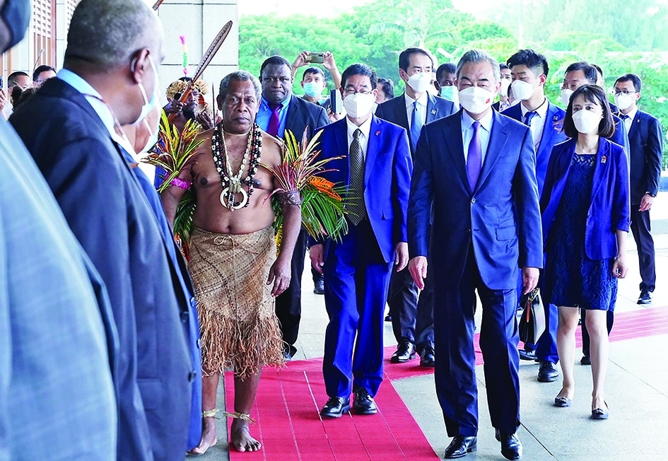 PORT VILA, Vanuatu: Visiting Chinese Foreign Minister Wang Yi ® arrives at the covention center with Chief of Malvatumauri National Council Willie Plasua (2nd L) after a meeting with the Vanuatu President Tallis Obed Moses in Vanuatu capital city of Port Vila on June 1, 2022. – AFP