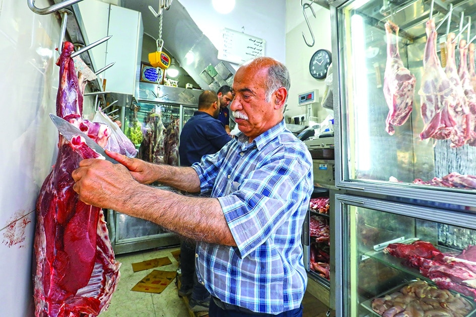 TEHRAN: A butcher prepares an order at his shop in Iran's capital Tehran. Iran has been wrestling with rampant price growth for years, exceeding 30 percent annually every year since 2018, according to the International Monetary Fund. - AFP