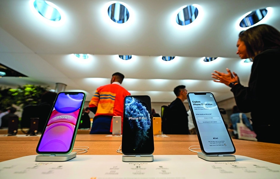 NEW YORK: In this file photo, the new iPhone are displayed inside the newly renovated Apple Store at Fifth Avenue in New York City. A majority of employees at a US Apple store have voted to form a union on June 18, 2022, a first for the tech giant, which has so far tried to discourage unionizing attempts. - AFP