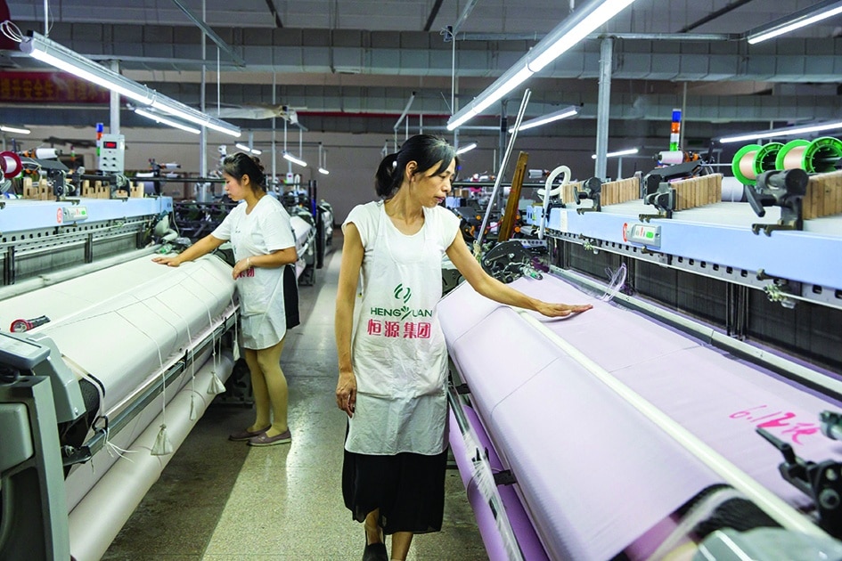 NANTONG: A worker produces silk products that will be exported at a textile factory in Nantong in China’s eastern Jiangsu province on June 15, 2022. - AFP