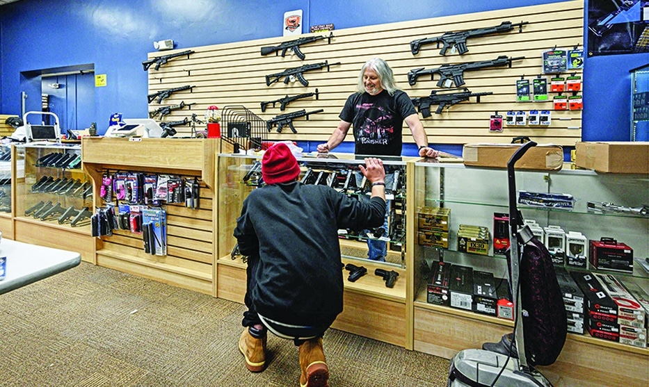 GOFFSTOWN, New Hampshire: A customer browses guns at RTD Arms &amp; Sport in on June 2, 2022. -  AFP