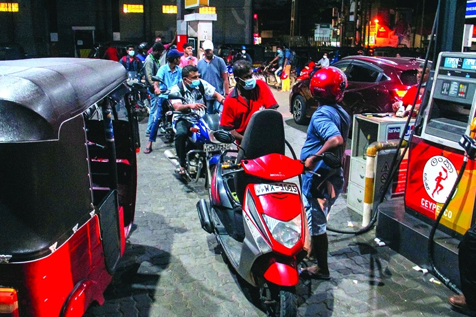 COLOMBO: Motorists queue to buy fuel at the Ceylon Petroleum Corporation fuel station in Colombo.- AFP