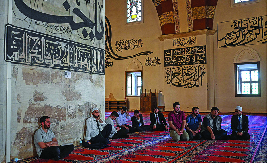 Participating muezzins wait to perform the Ezan call to prayer in front of a jury, in Old mosque (Eski Camii) in Edirne.- AFP photos