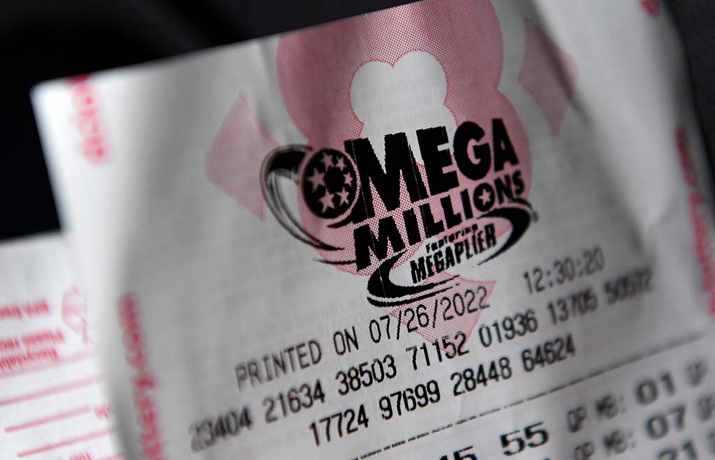 (FILES) This illustration file photo taken on July 26, 2022, shows a Mega Millions lottery ticket in Washington, DC. - The jackpot for the upcoming drawing of the Mega Millions lottery has ballooned to more than $1 billion USD, the fourth highest prize ever, its US organizer announced on July 27, 2022. (Photo by OLIVIER DOULIERY / AFP)