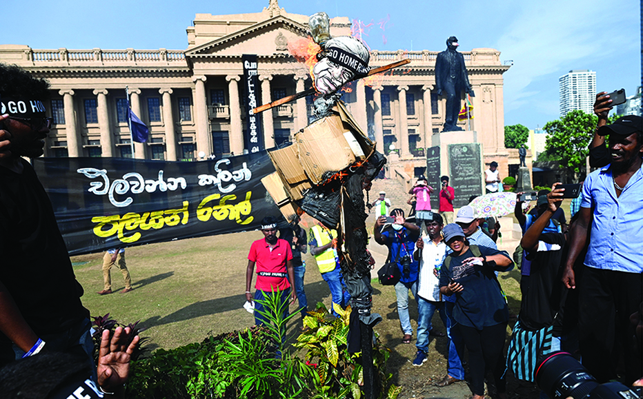 COLOMBO, Sri Lanka: Demonstrators burn an effigy of interim Sri Lankan President Ranil Wickremesinghe during a protest in front of Presidential Secretariat in Colombo on July 19, 2022. -  AFP