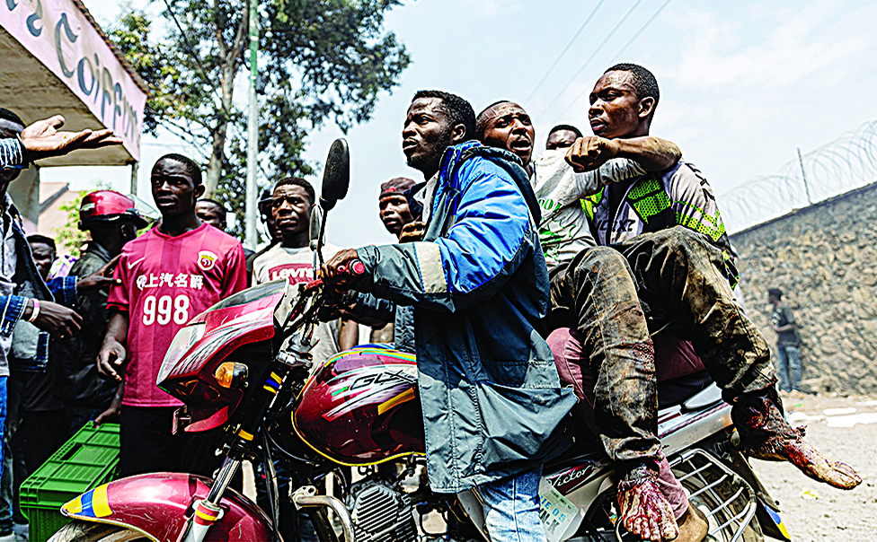 GOMA: A wounded man is rushed away on a motorcycle after protesters stormed and looted a warehouse belonging to the peacekeeping mission in the Democratic Republic of Congo (MONUSCO) at the UN facilities in Goma. - AFP
