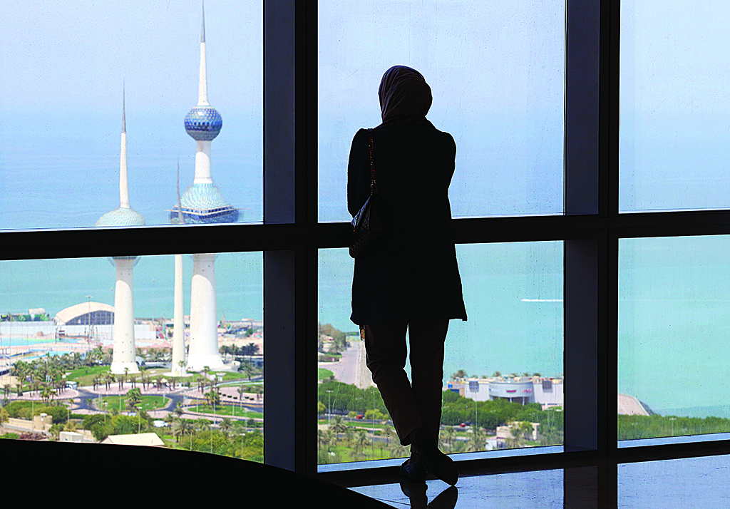 KUWAIT: A woman stares at the Kuwait Towers through a window from Al-Hamra Tower in Kuwait City, on July 27, 2022. - Photo by Yasser Al-Zayyat