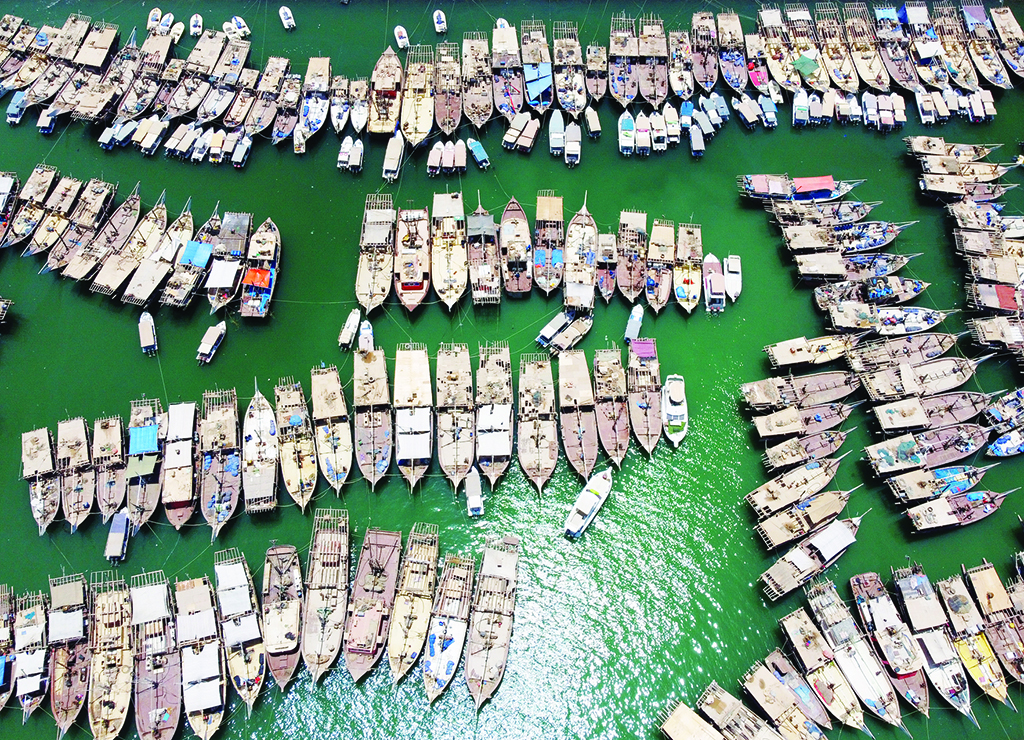 KUWAIT: An aerial view shows traditional fishing boats docked at the Souq Sharq harbor, in Kuwait City on July 3, 2022. - Photo by Yasser Al-Zayyat
