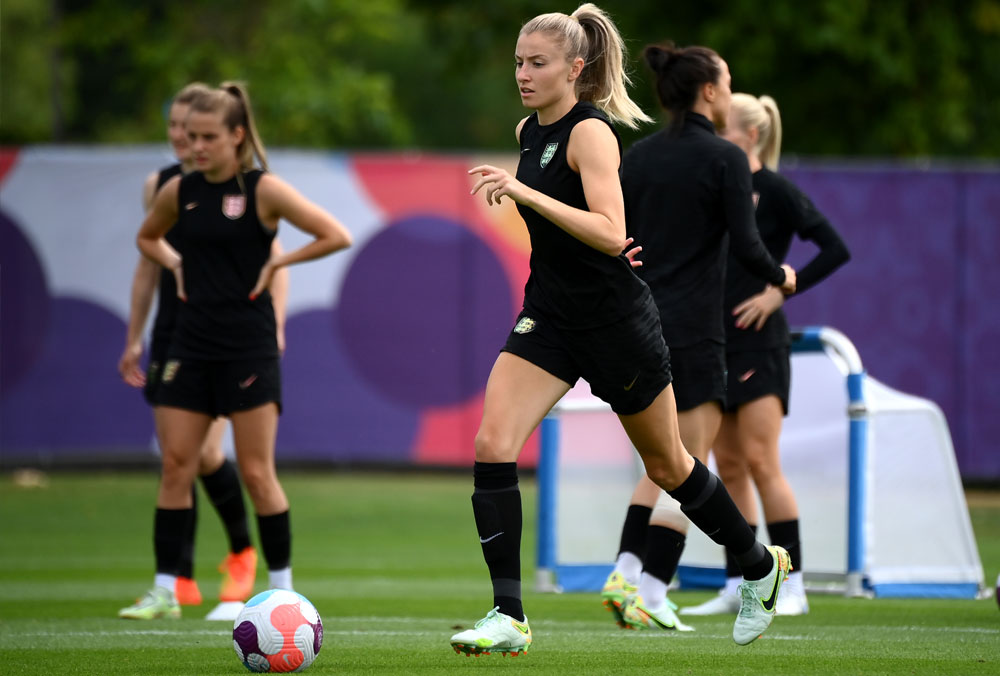 England's defender Leah Williamson (C) controls a ball during a team training session at their training camp at the Lensbury resort in Teddington on July 30, 2022