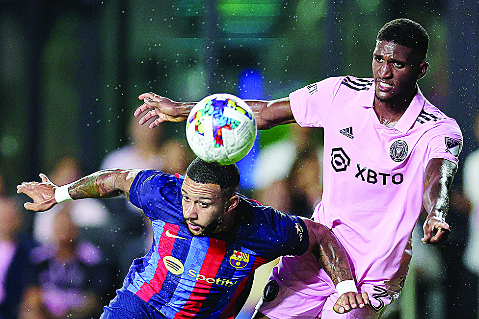 FLORIDA: Memphis Depay #9 of FC Barcelona heads the ball against Damion Lowe #31 of Inter Miami CF during the second half of a preseason friendly at DRV PNK Stadium on July 19, 2022.- AFP