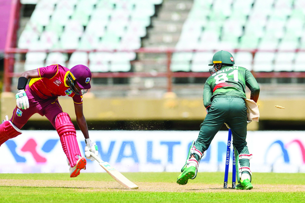 PROVIDENCE: Akeal Hosein (left) of West Indies is run out by Quazi Nurul Hasan Sohan of Bangladesh during the 2nd ODI match between West Indies and Bangladesh at Guyana National Stadium in Providence, Guyana, on July 13, 2022. - AFP