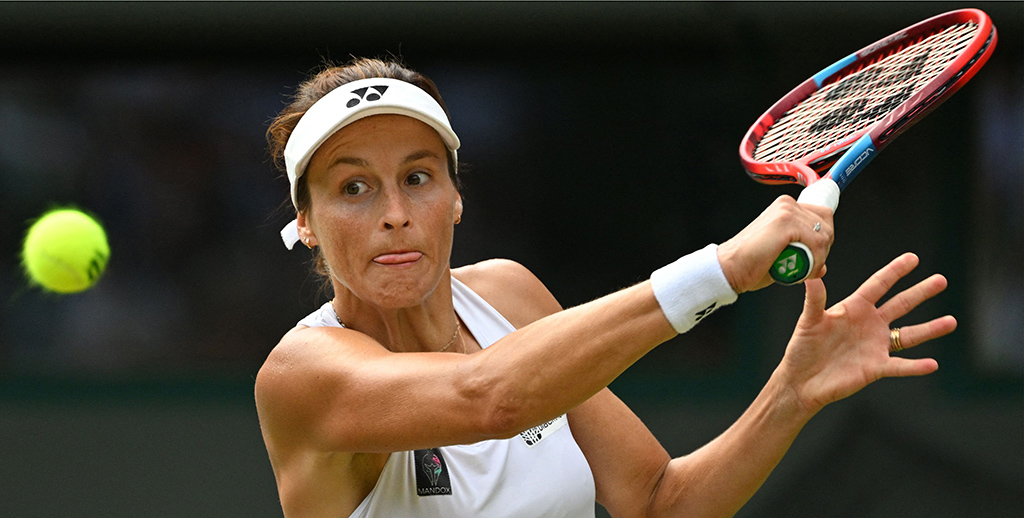 WIMBLEDON: Germany's Tatjana Maria eyes the ball as she returns it to Latvia's Jelena Ostapenko during their round of 16 women's singles tennis match on the seventh day of the 2022 Wimbledon Championships at The All England Tennis Club in Wimbledon, southwest London, on July 3, 2022. - AFP