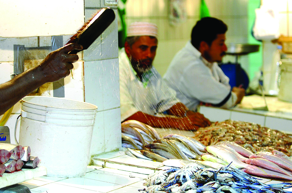 KUWAIT: A fish seller sprays water on the fish at Mubarakiya Market. Chairman of the Kuwait Farmers Union Abdullah Al-Damak said the union is committed to promoting food security in the country.- Photo by Yasser Al-Zayyat