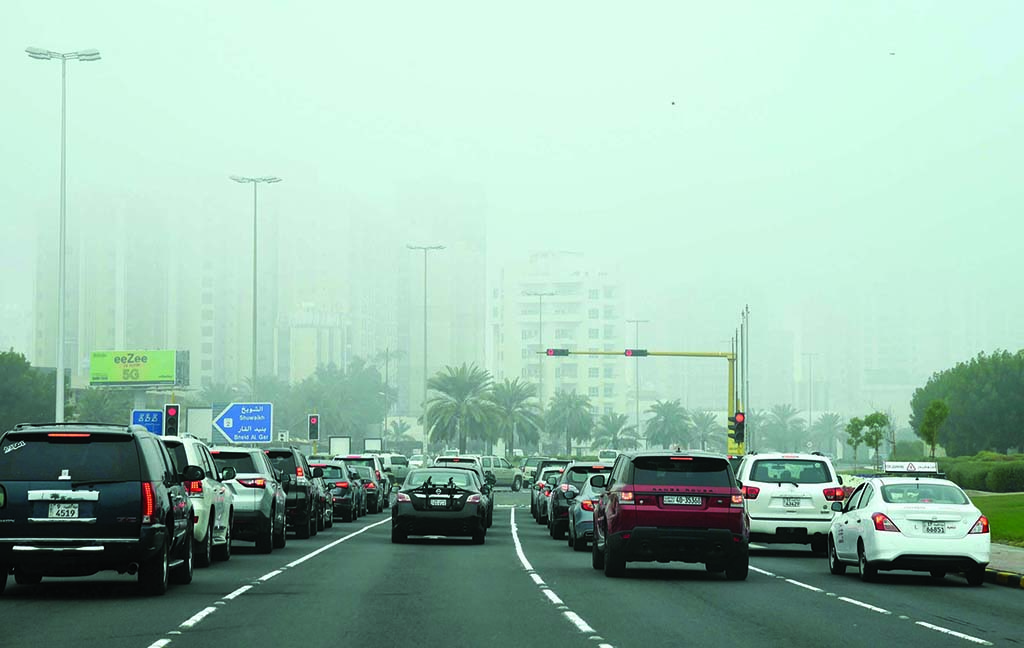 KUWAIT: Motorists wait at the traffic signal in Kuwait City. Ministry of Interior, on Thursday, called on drivers and beachgoers to exercise caution due to unstable weather. - Photo by Fouad Al-Shaikh
