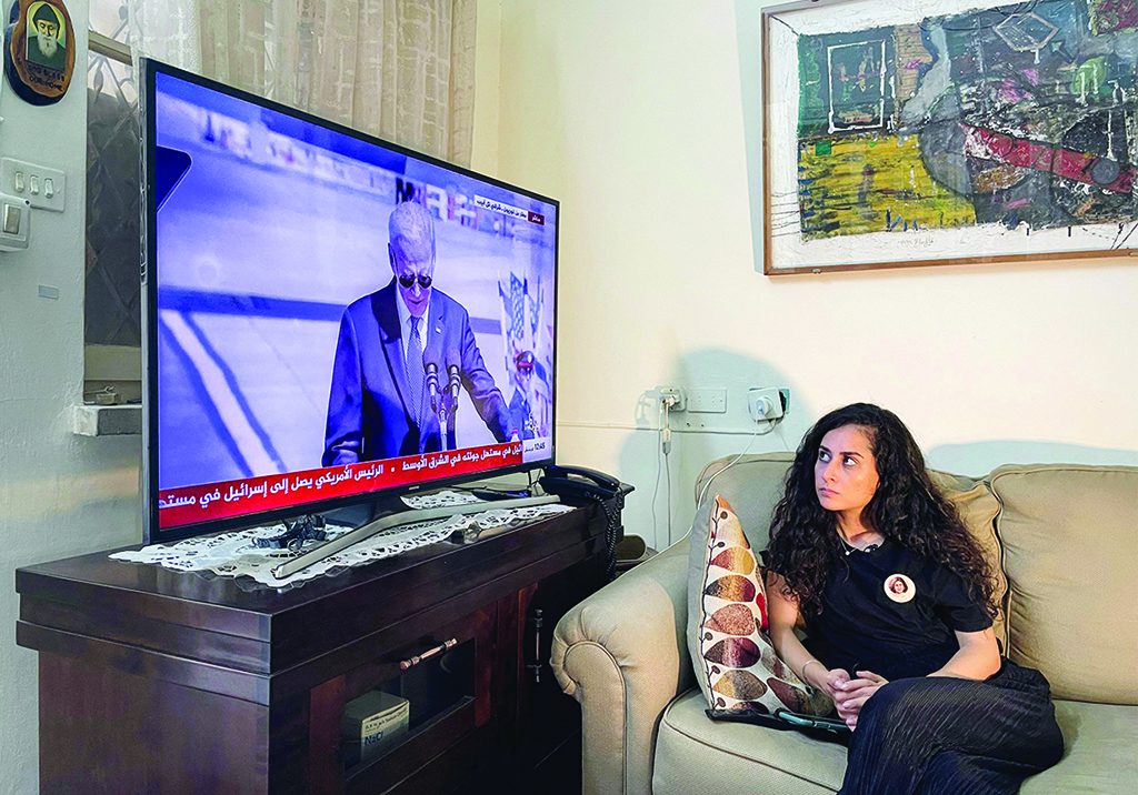 JERUSALEM: Lina Abu Akleh, the niece of slain Al Jazeera journalist Shireen Abu Akleh, watches on TV the speech of US President Joe Biden upon his arrival in Tel Aviv on July 13, 2022. - AFP