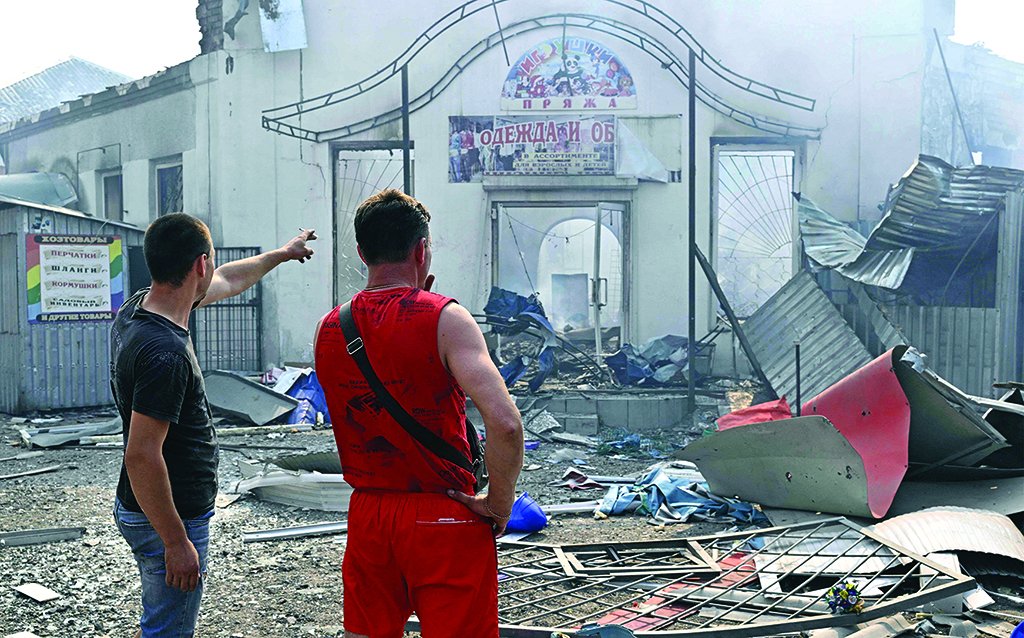 SLOVIANSK, Ukraine: Local residents view destroyed shops of a local market after a rocket attack on July 3, 2022 amid the Russian invasion of Ukraine. - AFP