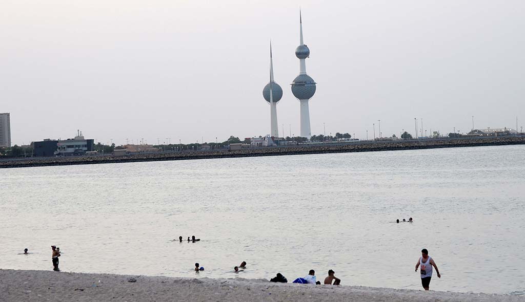 KUWAIT: This file photo shows people swimming at a beach in Kuwait. -  Photo by Fouad Al-Shaikh