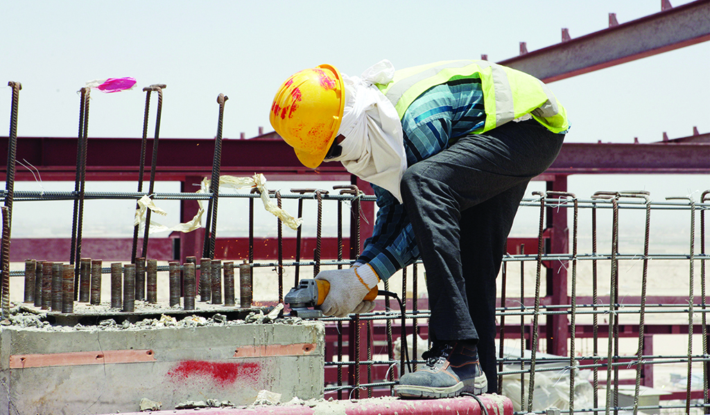 KUWAIT: This file photo shows a construction worker works at a construction site in Kuwait. - Photo by Yasser Al-Zayyat