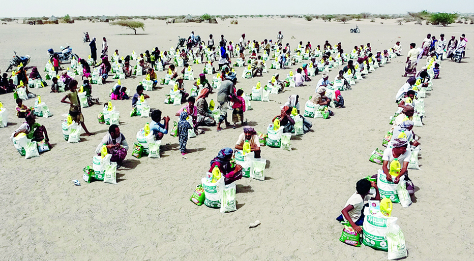 HAYS: Yemenis displaced by the conflict receive food aid and supplies to meet their basic needs, at a camp in Hays district in the war-ravaged western province of Hodeida, on July 6, 2022. - AFP
