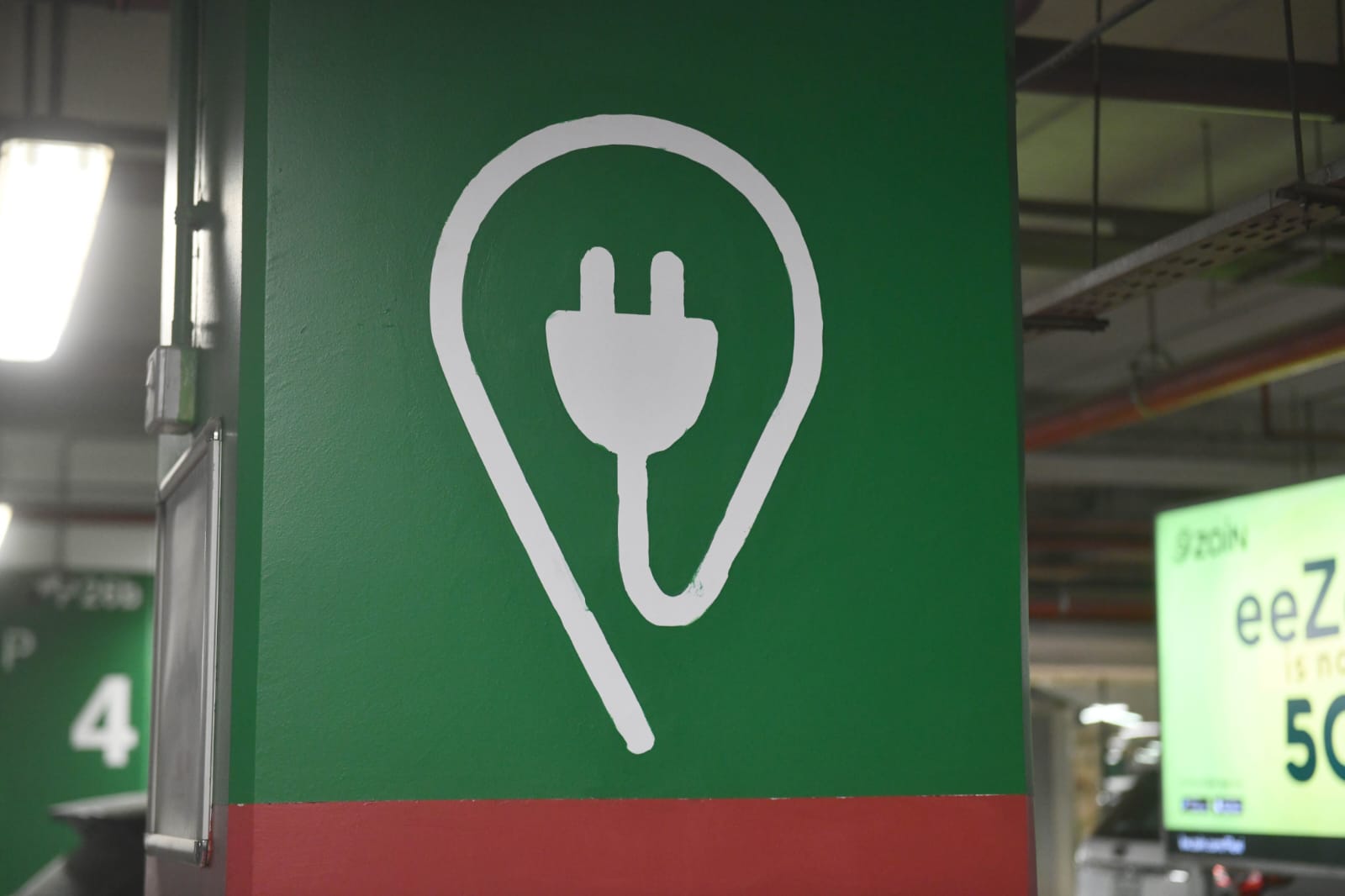 Signage indicating that the spot is used to recharge electric vehicles.<br>