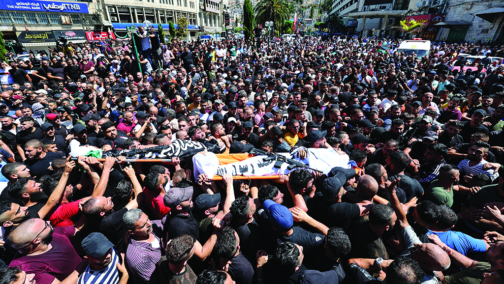 NABLUS, Palestinian Territories: Mourners carry the bodies of Muhamad Azizi, 25, and Abdul Rahman Jamal Suleiman Sobh, 28, killed earlier in Zionist attacks in the old quarter of the West Bank city of Nablus, during their funeral procession in the same city, on July 24, 2022. - AFP