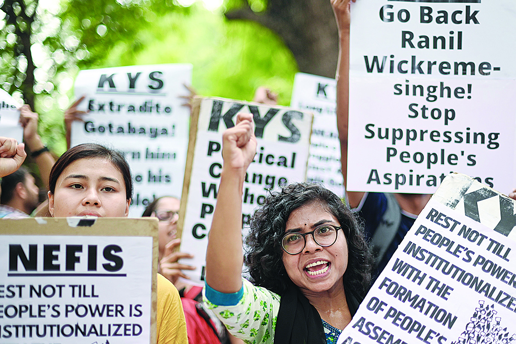 NEW DELHI, India: Demonstrators hold placards as they shout slogans during a protest in solidarity with the people of Sri Lanka on the 100th day, in New Delhi on July 17, 2022. - AFP