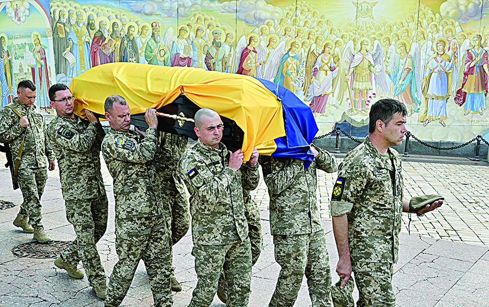 KYIV, Ukraine: Ukrainian servicemen carry coffin of a fellow officer nicknamed Fanat during his funeral in Kyiv on July 18, 2022.— AFP